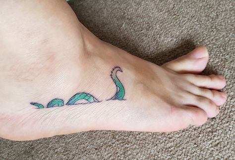 Loch Ness Tattoo. I like to think this wee Scottish monster is a little whimsical but badass. Lock Ness Monster Tattoo, Lockness Monster Tattoo, Loch Ness Monster Tattoo, Nessie Tattoo, Cryptid Tattoo, Scotland Tattoo, Monster Tattoo, Scotland Vacation, Highland Cow Art