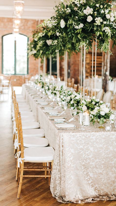 Pure Luxe Bride helped pick these champagne lace tablecloths and tall greenery centerpieces to fill the exposed brick industrial wedding venue at the Cedar Room in Charleston! Lace Wedding Table Decor, Lace Tablecloth Wedding, Wedding Reception Rooms, Greenery Wedding Centerpieces, Cedar Room, Tall Wedding Centerpieces, Nye Wedding, Wedding Tablecloths, Winter Wonderland Wedding