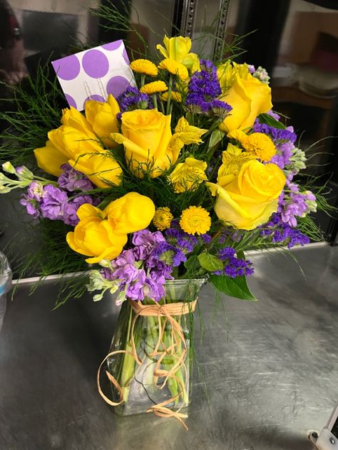 Yellow Roses, Yellow Button Mums, Purple Stock, Purple Statice, Yellow Aloestomeria, Tree Fern Purple And Yellow Roses, Yellow Purple Flower Arrangement, Yellow Roses Flower Arrangements, Yellow And Purple Flower Arrangements, Purple And Yellow Flower Arrangements, Purple And Yellow Bouquet, Yellow Roses Arrangement, Purple Statice, Yellow Flower Arrangements