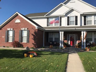 Exterior paint, red brick, black board and batten shutters, white siding, white trim Red Brick White Siding Black Trim, White House Black Trim Red Brick, White Siding Red Brick Exterior, White Siding House, White Siding Exterior, Black Board And Batten, White Vinyl Siding, Split Level House Exterior, Red Brick Exteriors