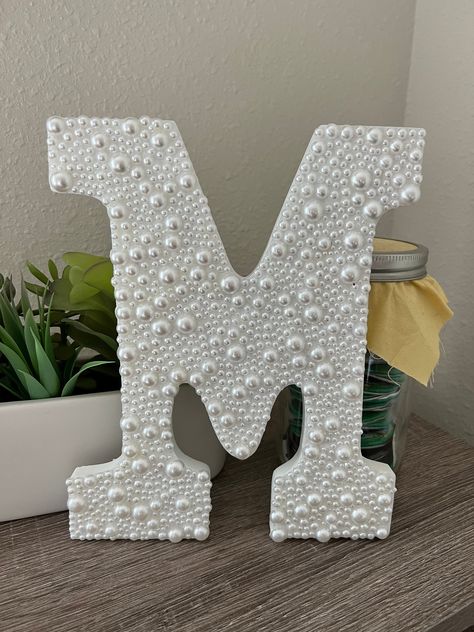 White Wooden Letter Embellished with Pearl (not real) gems. Adhered with high quality glue to ensure long lasting quality.  The sides and back remain un-pearled and in their original condition These might be able to stand on the table if they are letters like "n" or "m" however letters like "c" or "s" might have to be leaned up against something. These are WALL HANGING LETTERS. No guarantees that your letter will stand up on its own without support All letters A-Z available and & sign available Pearl Sorority Letters, Sorority Letters Painted Wooden Big, Sorority Room Decor, Wood Letter Painting Ideas, Wood Letters Decorated, Wooden Letter Ideas, Big Little Basket, Bridal Decor, Decorated Letters