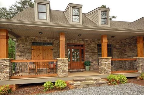 Stone columns adorn the covered front porch along with a solid wood front door and accent shutters and garage door. Description from sheelahclarkson.com. I searched for this on bing.com/images Farmhouse Front Porch Decor, Porch Pillars, Farmhouse Front Porch Ideas, Veranda Design, Front Porch Columns, Stone Porches, Porch Remodel, Stone And Wood, Building A Porch