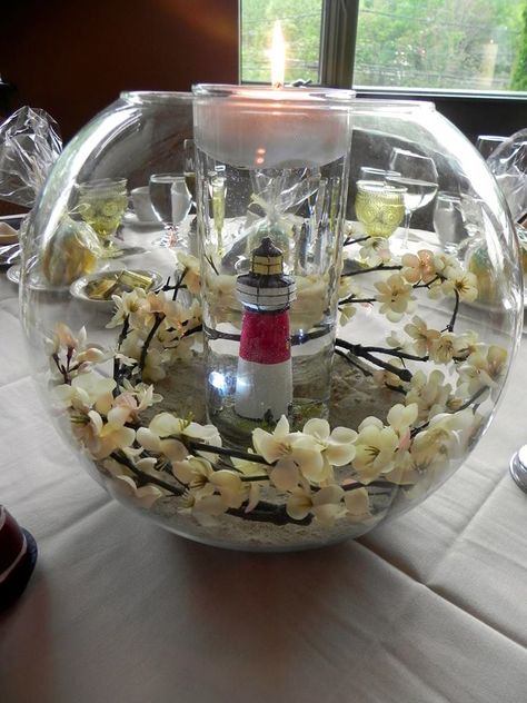 TABLE DECOR: lighthouse in center and use water and lighted up blue gems, sea shells, moon rocks on bottom instead of flowers to surround and add flower Lighthouse Wedding Theme, Lighthouse Wedding, Lighthouse Decor, Elopement Reception, Instead Of Flowers, Thanksgiving Wedding, 60 Wedding Anniversary, Centerpieces Wedding, Tea Party Decorations