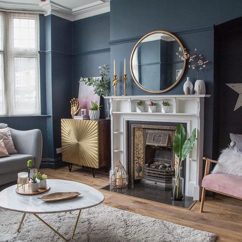 Living room makeover with dark blue walls, pink sofa and gold accessories  Dark coloured walls for Kate Beavis Your Vintage Life, vintage blogger, writer and speaker on homes, fashion, weddings and lifestyle. #darkwalls #bluewalls #wallpaper #paint #home #alternative #decor #design #yourvintagelife Dining Fireplace, Blue And Gold Living Room, Rosa Sofa, Blue Walls Living Room, Fire Surrounds, Navy Living Rooms, Quilted Cushion, Victorian Living Room, Dark Living Rooms