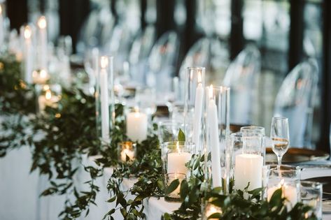 Head table with trailing greenery down the front, taper candles, pillar candles, and votive candles interspersed. @parsonageevents Candle Head Table, Front Taper, Taper Candle Centerpiece, Pilar Candles, Head Table Wedding, Head Table, Candle Centerpieces, Wedding Table Centerpieces, Wedding Candles