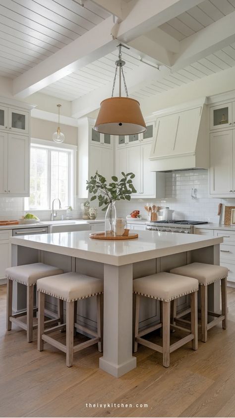 Modern kitchen with a large central island, white cabinets, and a hanging pendant light. 4x6 Island Kitchen, Interior Design Kitchen With Island, Island With 6 Seats, Kitchen Island With Built In Table, Large Kitchen Islands With Seating, Island Booth Design, Basement Island Bar Ideas, Back Of Island Ideas, Kitchen With Island And Dining Table