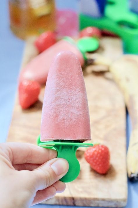 These Strawberry & Banana Ice Lollies (Popsicles) use seasonal strawberries, bananas, yogurt & touch of honey. Wholesome, refined sugar free & so delicious! #strawberryicelollies #bananaicelollies #yogurticelollies #popsicles #strawberrybananapopsicles #healthyicelollies #refinedsugarfreeicelollies Strawberry Ice Lollies, Strawberry Yogurt Cake, Childrens Party Food, Banana Popsicles, Banana Yogurt, Strawberry Brownies, Ice Lollies, Kitchen Larder, Strawberry Muffins