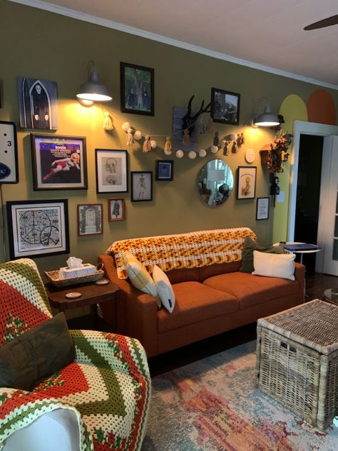 Loving my orange sofa and added some crochet along with retro colors to the wall. Love my gallery wall too Orange Couch Green Walls, Orange Sofa Green Wall, Orange Living Room Walls, Orange Couch, Orange Sofa, Room 2023, Paint Inspo, Green Couch, Living Room Orange