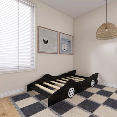 If you want an eye-catching bed, This bed with an appealing race car design will be perfect for your bedroom. Comfortable, functional, and aesthetically pleasing, this bed is designed to ensure comfort and maximum safety. Crafted from high-quality materials, this bed has a strong construction. This bed comes with rails on both sides to prevent you from falling out of the bed. The sturdy slats offer the needed support and can withstand daily wear and tear. Size: Twin, Color: Black | Zoomie Kids A Toddler Boy Car Theme Bedroom, Race Car Toddler Room, Car Toddler Room, Racing Bedroom, Boy Car Room, Toddler Car Bed, Race Car Design, Kids Daybed, Car Themed Bedrooms