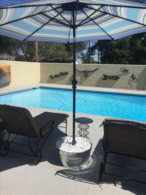 A solution to umbrella stands that won't hold up in the wind:  put the umbrella stand in a galvanized bucket or wood planter and fill it with rocks.  It's not going anywhere! Umbrella Stand Diy, Diy Umbrella, 1970s House, Outdoor Umbrella Stand, Pool Umbrellas, Backyard Shade, Patio Umbrella Stand, Diy Swimming Pool, Wood Planter