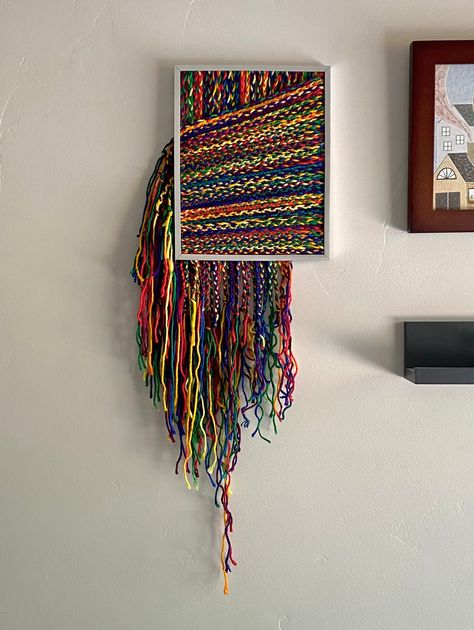 This ADHD creation features hand braided yarn attached to the glass portion of the frame. Vibrant colors make this a playful addition to your art collection! Blanket As Wall Art, Yarn Pictures Art, Yarn Room Ideas, Yarn Canvas Art, Yarn Art On Canvas, Crochet Art Wall, Rope Painting, Mexican Yarn Art, Yarn Art Wall