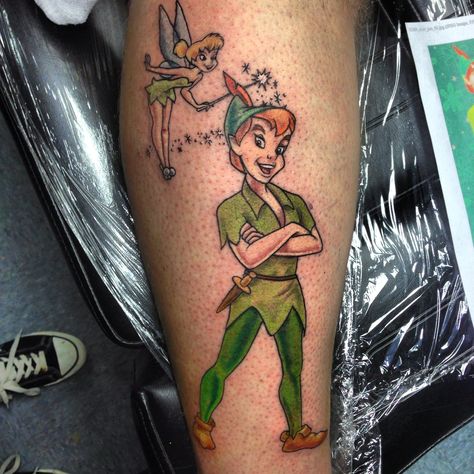 My New Peter Pan tattoo. Peter Pan Tattoos, Neverland Tinkerbell, Tinkerbell Tattoo, Pan Tattoo, Tinker Bell Tattoo, Peter Pan Tattoo, Small Tattoo Placement, Peter Pan And Tinkerbell, Tattoo Color