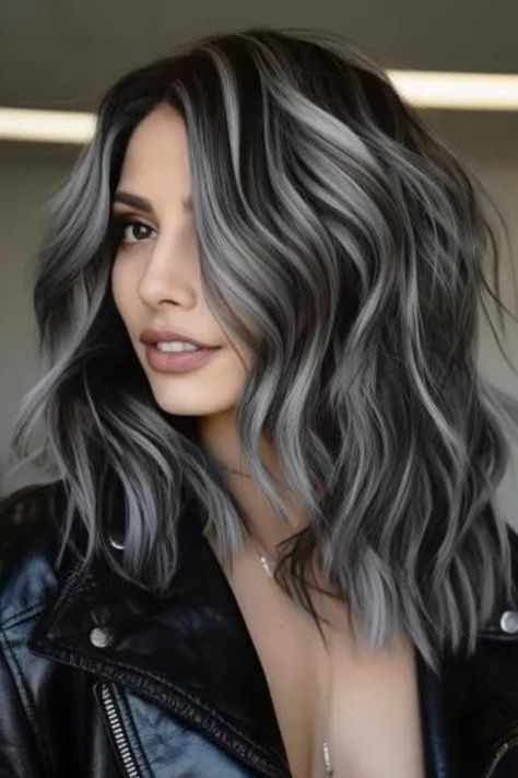 Charcoal black waves with silver streaks make a bold and fashion-forward statement for medium-length hair. Medium barrel curl and texture spray. It is ideal for fine hair and suits a round-shaped face. Click here to check out more trending medium-length wavy hairstyles this year. Very Long Bob, Charcoal Hair, Black And Grey Hair, Black Waves, Transitioning Hair, Medium Length Wavy Hair, Grey Hair Transformation, Grey Hair Inspiration, Texture Spray