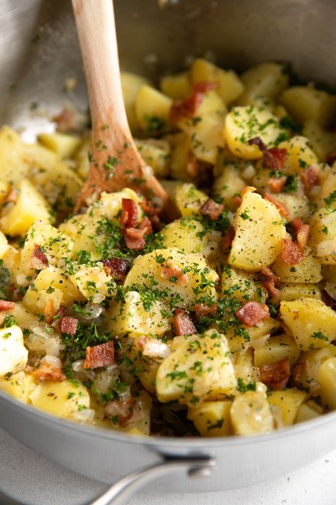 This traditional German Potato Salad Recipe is a hot potato salad made with tender cooked potatoes, crispy bacon, and sautéed onions in a delicious tangy mustard vinaigrette. The ultimate warm and hearty side dish, perfect for any occasion. Warm German Potato Salad, Cooked Onions, German Potato Salad Recipe, Picnic Potluck, Potatoes Crispy, Potato Salad Dressing, Mustard Vinaigrette, German Potato, German Potatoes