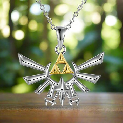 Embrace the power of the legendary Triforce with this exquisitely crafted necklace. Made from premium 925 sterling silver, this stunning piece features the iconic Triforce symbol with silver wings and three gold-plated triangles. Perfect for any Legend of Zelda fan, this necklace is a beautiful blend of elegance and fandom, designed to last a lifetime. Whether you're fighting for Hyrule or simply adding a touch of magic to your everyday look, this Triforce necklace is a must-have treasure. . ... Triforce Symbol, Zelda Cosplay, Anime Jewelry, Silver Wings, Breath Of The Wild, The Legend Of Zelda, Jewelry Lover, Legend Of Zelda, Triangles