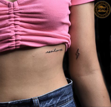 Resilience; “ the ability to withstand adversity and bounce back from difficult life events” With thunderbolt signifies power, strength, and intelligence. Inked at @original_mac_tattoos #hauzkhas ( We do not have any other branch ) For appointments do call or what’s app us on : +91 8851 012 863 +91 7042 130 654 Thanks for looking 😊 #smalltattoosforgirls #quotetattooideas #scriptattoos #delhitattoos #delhitattooshop Thunderbolt Tattoo, Small Girl Tattoos, Bounce Back, Small Tattoo, Tattoo Shop, Girl Tattoos, Jesus Fish Tattoo, Small Tattoos, Tattoo Quotes