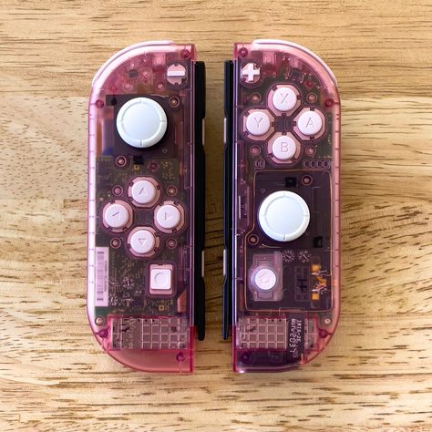 Clear pink Joycons for the Nintendo Switch with white buttons. Custom Nintendo Switch Joy Cons, Nintendo Switch Customization, Switch Customization, Custom Joycons, Custom Nintendo Switch, Switch Controllers, Pink Switch, Gaming Nostalgia, Hello Kitty Games