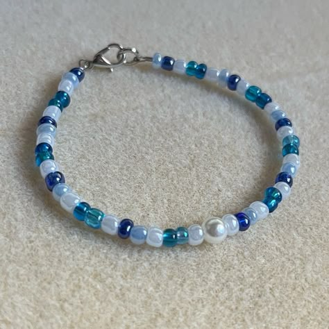 - One Of A Kind Beaded Bracelet - Featuring White, Light Blue, Dark Blue, And Translucent Blue Seed Beads, And White Pearl Center - Silver Colored Hardware - Clasps Closed. No Stretch. - Size/ Circumference Is 7.5” (See Picture) - Handmade (By Myself). Perfect To Treat Yourself Or To Give As A Gift! **Add 2 Jewelry Items Marked “2 For $20” To Your Bundle And I Will Send You An Offer For $20** Check Out The “Boutique” Tab In My Closet For Handmade Earrings, Bracelets, And Necklaces! Bracelet Inspo Seed Beads, Blue Seed Bead Bracelet, Beaded Bracelets Blue, Cute Beaded Bracelets, Blue And White Bracelet, Light Blue Bracelet, Marc Jacobs Bracelet, Ombre Bracelet, Brighton Bracelets