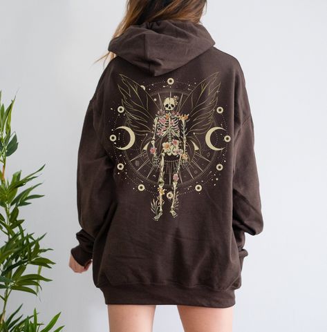 Fairy Grunge Aesthetic with Skeleton Butterfly Wings is a perfect gothic Fairycore hoodie for people who loves Witchcore and Fairywave. Add this cute and creepy y2k grunge fairycore design to your aesthetic clothes collection. Available on tshirt, sweatshirt and hoodies: https://www.etsy.com/shop/TheNims?search_query=fairy+grunge Browse through my other awesome items here: http://thenims.etsy.com/ ABOUT THE PRODUCT: Unisex Heavy Blend™ Hooded Sweatshirt | GILDAN 18500 (Customer Favorite) Everyon Tshirt Over Hoodie Outfit, Creepy Y2k, Dark Fairy Aesthetic Clothes, Witch Aesthetic Clothes, Y2k Grunge Clothes, Fairycore Design, Skeleton Clothing, Grunge Hoodies, Fairy Skeleton