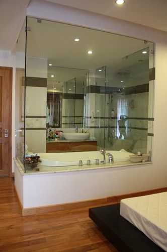 Love this glass wall to open up a small bathroom and bedroom! Transparent Bathroom In Bedroom, Glass Wall Ensuite, Bathroom Glass Wall Bedroom, Bathroom With Glass Wall To Bedroom, Glass Wall Bathroom Bedroom, Bathroom With Glass Wall, Bedroom And Bathroom In One, Bathroom Plants Ideas, Cozy Bathroom Design