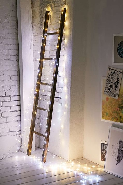 Make a decorative ladder Christmas-ready by encasing it in lights. Ladder Christmas Decor, Wooden Ladder Ideas, Ladder With Lights, Wood Ladder Decor, Rustic Ladder Decor, Wooden Ladder Decor, Wooden Blanket Ladder, Old Ladder, Rustic Ladder