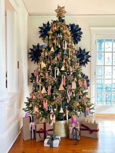 Pink and navy can be festive Christmas colors! Use navy gift bags to make giant snowflakes for added drama. #christmastreeideas #christmasdecor #pinkchristmas #christmastreedecor Pink Blue And Green Christmas Tree, Pink Blue Green Christmas Tree, Navy And Pink Christmas Tree, Pink And Navy Christmas, Pink And Blue Christmas Tree, Anthro Christmas, Navy Christmas Tree, Giant Snowflakes, Nutcracker Christmas Tree