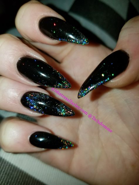 Dark Stilleto Nails Design, Rock Concert Nail Art, Black Hologram Nails, Black Glitter Stiletto Nails, Black Stiletto Nails With Rhinestones, Short Black Stiletto Nails, Black Stilleto Nails Designs, Black Holo Nails, Black Iridescent Nails