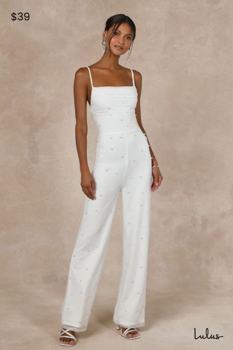 Stride into your next event looking like a dream come true in the Lulus Unbelievably Divine White Mesh Pearl Lace-Up Jumpsuit! Stretchy, airy mesh knit (adorned with gleaming faux pearls throughout) shapes this special jumpsuit with adjustable spaghetti straps, a cowl neckline, and a fitted bodice. High, fitted waist tops straight pant legs that fall to full-length hems. Turn around to show off a lace-up detail at the back for an alluring finish. Hidden back zipper/clasp. Fit: This garment fits true to size. Length: Ankle length. Bust: Great for any cup size. Waist: Fitted - very fitted at natural waist. Hip: Fitted - stretchy fabric allows room for hips. Undergarments: May be worn with an adhesive bra, petals, or no bra. Fabric: Fabric is very stretchy. Lined. Shell: 95% Nylon, 5% Spandex Ivory Jumpsuit Wedding, White Glitter Jumpsuit, Reception Jumpsuit, Divine White, Glitter Jumpsuit, Pearl Lace, Wedding Jumpsuit, Pearl And Lace, Adhesive Bra