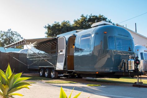 Photo 1 of 17 in A 1984 Airstream Shines With a Steely-Blue Shell and a Cozy Farmhouse Interior - Dwell Airstream Exterior, Farm Style Sink, Airstream Argosy, Custom Mercedes Benz, Airstream Restoration, Custom Mercedes, Maple Stain, Airstream Renovation, Rv Campgrounds