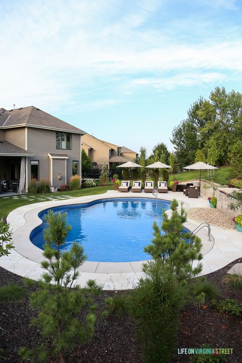 Gorgeous oasis shaped vinyl pool. Striped umbrellas, striped outdoor curtains, lounge chairs, waterfall, stone veneer, oleander and pine trees. Inground Pool Designs, Life On Virginia Street, Pools Backyard Inground, Vinyl Pool, Backyard Pool Landscaping, Pool Construction, Hello Monday, Backyard Paradise, Building A Pool