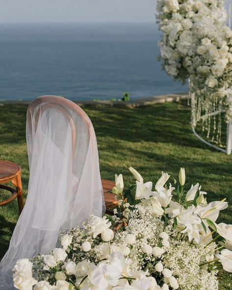 It's the simple touches that can really elevate your garden wedding, taking it from cutesy to elegant. 🤍 These organza sheets are casually draped over wooden chairs, instantly creating movement and drama, and giving this ceremony an ethereal feel. Coupled with the all-white florals, and echoing the light fluffy clouds, for me, this is perfection. If you want to elevate your wedding decor without spending a fortune, then it's the little details like these that can make all the difference.... Ceremony Chairs, Sustainable Decor, Wooden Chairs, Fluffy Clouds, Sustainable Wedding, Creative Wedding Ideas, Eco Friendly Wedding, Bali Wedding, Digital Weddings