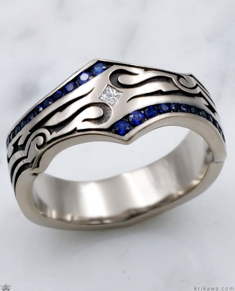 This phenomenal wedding band for men was inspired by tribal tattoo imagery. Over one quarter carat of blue sapphires is channel set in the ring, with a white princess cut diamond flush set diagonally in the center. The recesses are darkened. Truly a stand apart ring. To choose different colors for the accents in the channels, just select your choice of fancy diamonds or sapphires! Mens Sapphire Wedding Band, Stylish Gold Earrings, Engagement Ring Non Traditional, Necklace Women Gold, Women Gold Chain, Jewelry Rings Unique, Blue Wedding Band, Dream Wedding Ring, Sapphire Wedding Rings