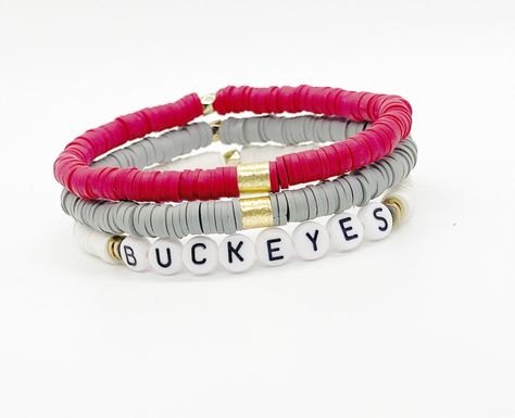 "Support your team with our Gameday Line! Don't see your team colors? Message us as we can make any team set! Bracelet Set includes all 3 bracelets shown. Made to fit a 7-7.5\" wrist comfortably but can be made smaller or larger! Adjustable stretch bracelets ❤️" Ohio State Clay Bead Bracelet, Gameday Bracelets, Buckeye Jewelry, Football Jewelry, Clay Bracelets, Stacked Bracelets, Diy Necklaces, Set Bracelet, Clay Bracelet