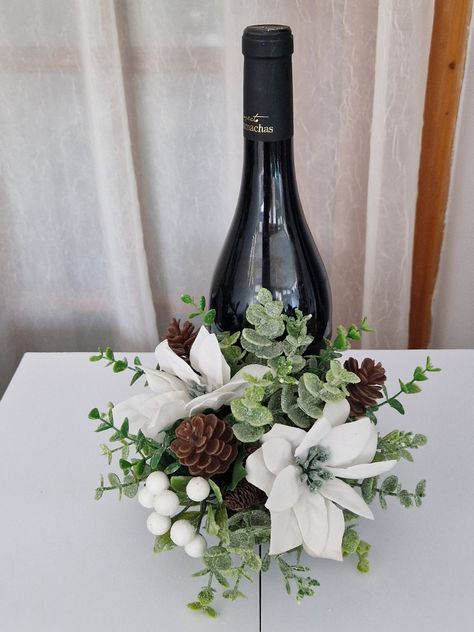 These wine bottle flower arrangements can sit at the bottom or top of the bottle. These make lovely centerpiece for a table, or standing alone. Also great for making a wine bottle gift that extra special keepsake.  THE ROSE BUDS ARE DEEPER RED THAN SHOWN Each arrangement is roughly the same size.  20cm high x 19cm wide.  Any questions feel free to ask Diy Flower Stand Centerpiece, Wine Bottle Table Decor Wedding, Table Decor With Wine Bottles, Wine Bottle Floral Arrangements Diy, Wine Bottles With Flowers, Wine Bottle Centerpieces With Flowers, Speakeasy Centerpieces, Wine Flower Arrangements, Tequila Centerpiece Ideas