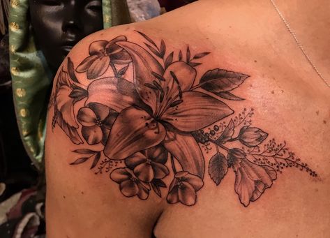 Black and grey lily shoulder tattoo Lily Shoulder Tattoo, Lace Shoulder Tattoo, Shoulder Cap Tattoo, Flower Shoulder Tattoo, Lillies Tattoo, Butterfly Tattoo On Shoulder, Lily Flower Tattoos, Rose Tattoo Sleeve, Rose Shoulder Tattoo