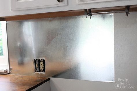 Install Your Own Magnetic Metallic Backsplash, this is inexpensive and should be really easy to clean. Sheet Metal Backsplash, Metal Backsplash, Paint Backsplash, Backsplash Wallpaper, Stainless Steel Backsplash, Steel Backsplash, Farmhouse Backsplash, Unique Backsplash, Grey Backsplash