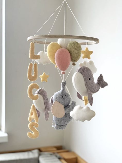 Personalized felt baby mobile with Elephant and Whales. The mobile includes: - one elephant - two whales - name (maximum 5 letters) - four balloons - three stars - three clouds Diy Baby Mobile Tutorial, Elephant Baby Mobile, Felt Baby Mobile, Mobiles For Kids, Baby Mobile Felt, Whale Nursery, Diy Baby Mobile, Flying Elephant, Diy Bebe