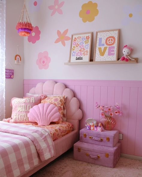 This punchy girl's bedroom boasts a pink scalloped bed dressed in white and pink bedding. The bed is set against pink vertical shiplap wainscoting fitted under a light wood floating shelf. Go all out with the pink color scheme with pink stacked trunks used as a nightstand. Pastel Curtains, Pastel Lighting, Bedding Minimalist, Pastel Furniture, Pastel Inspiration, Room Pastel, Pastel Home, Pastel Accessories, Pastel Paint