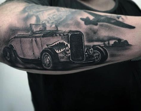 This black-and-white design shows a retro car with a plane flying above it. It appears to be from the 1920s-1930s. Smoke rises from the car. This is a stylish choice for history buffs! #tattoos #tattoofriday #tattooart #tattoodesign #cartattoos #simplecartattoos #carlover #memorabletattoos #carfashion Hot Rod Tattoo, Truck Tattoo, Mens Tattoos, Mechanic Tattoo, Tattoo Zeichnungen, Chest Tattoos, Car Tattoos, Tattoo Collection, Geniale Tattoos