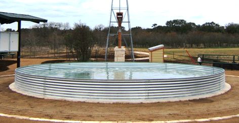 This bottomless stock tank has a concrete pad poured in and around the edge to create a water barrier against the ground.. Water Trough Pool, Poly Stock Tank, Large Stock Tank, Cowboy Pool, Stock Tank Swimming Pool, Tank Swimming Pool, Diy Stock Tank, Stock Tank Pool Diy, Water Trough