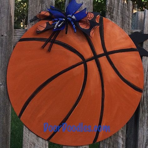 "Measuring in at 20\", this 3/8\" thick wooden circle is transformed into a basketball with traditional orange & black. I can create your basketball in any colors! Back is painted solid color. Ready to hang on wire loop and embellished with coordinating ribbons. If you don't want the ribbons, I can skip those! I use outdoor quality paints and sealers to provide a superior product. Enjoy your creation for years to come by hanging on a covered porch or behind a screen door to protect is from w Basketball Door Hanger, Ball Painting, Custom Front Doors, Stylish Doors, Burlap Door Hangers, Wood Door Hangers, Wooden Door Hangers, Hanging Wreath, Diy Door