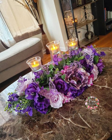 "💜 PURPLE PARADISE! 💜 This piece features abundant shades of purples in various florals, my classic 3 piece vase candles, and a touch of purple butterflies! 🦋 nothing left to be desired here!!  Centerpiece measures roughly 21\" long 9\" wide and 12\" tall with vases." Purple Table Decor, Purple Table Settings, Centerpiece Purple, Royal Blue Wedding Theme, Purple Sweet 16, Butterfly Centerpieces, Purple Wedding Decorations, Purple Centerpieces, Summer Centerpieces