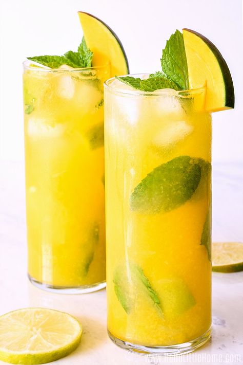 Easy Mango Mojito Recipe ... a refreshing Fresh Mango Cocktail that’s impossible to resist! Learn how to make the BEST Mango Mojito using simple, delicious ingredients: fresh mango puree, mint, lime, club soda, and rum. This Mango Mint Mojito is an Easy Light Rum Cocktail Recipe with tropical flair that’s as perfect for relaxing afternoons as it is for your next party. Best of all, this mouthwatering Mango Rum Drink is fast to make ... it’s the perfect Summer Drink! | Hello Little Home Mango Rum Drinks, Mango Mojito Recipe, Mojito Recipe Classic, Mango Cocktail, Mojito Ingredients, Mango Rum, Mango Mojito, Rum Cocktail Recipes, Perfect Summer Drink