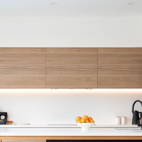 CompleteKitchens on Instagram: "The warm Prime Oak and cool Absolute Matt Black cabinetry work together to create a warm and modern feel.

Milky white Palm Shade Caesarstone was chosen for the benchtop and splashback, which perfectly “disappear” in the space to provide the balance and contrast. 

The island’s support legs and frame are made of Tasmania Oak timber, stained to match the flooring, adding a sense of cohesion and sophistication to this edgy and modern kitchen space. 

#kitchendesignideas #kitchenreno #modernkitchens #contemporarykitchen #customkitchen #bespokekitchen" Black Cabinetry, Prime Oak, Kitchen Reno, Milky White, The Balance, Custom Kitchen, Tasmania, Kitchen Space, Contemporary Kitchen