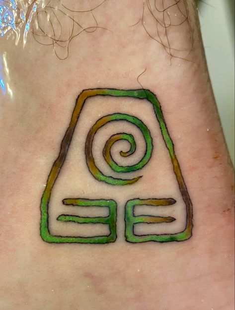 A watercolor tattoo of the Earthbender Symbol from the animated series Avatar the Last Airbender. Colors are in Earth Tones of the following: Forest, Moss, Dirt, and Sand. Earth Bender Symbol, Avatar Earth Symbol Tattoo, Earthbender Tattoo, Earth Bending Tattoo, Earth Bender Tattoo, Last Air Bender Tattoo, Earth Symbol Tattoo, Earth Bending, Earth Symbols