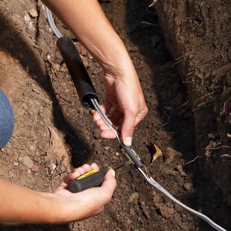 Accidentally cut an underground electrical wire? The easiest way to repair it is with an underground splice kit, which uses a rustproof connector and heat-shrink tubing to repair and seal the break. Telephone Cables, Home Electrical Wiring, Phone Jack, Low Voltage Lighting, Hot Melt Adhesive, Diy Electrical, Lamp Cord, Electrical Tape, Family Handyman