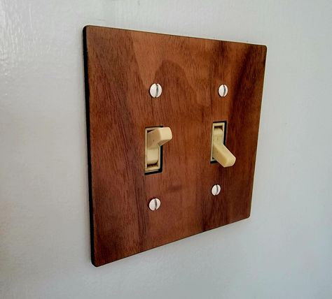 Up your light switch game! These fit standard toggle switch plates. Available in Walnut (shown), Cherry, and Maple. Specify 1, 2, 3, or 4 switches! Looking for large toggle switch style covers? Let me know, and I can also create those. These can also be made as custom orders with custom laser etching - light names, images, etc. Please contact me for more information for a custom order. Please reach out with any questions or issues!   These items are mostly made to order, and may take a couple of Wood Outlet Covers, Light Names, Vintage Eclectic Home, Light Switches And Sockets, Switch Socket, Surf House, Toggle Light Switch, Light Switches, Gravure Laser