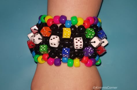 Rainbow and Black dice   Kandi  cuff  made with pony beads and stretch cord made with the X base  stitch cuff  Shipping please note I am UK based - It should take 3-7 days in the UK I ship first class Royal mail For international orders it can take 7 days to 4 weeks depending on where you are located please let me know if you have a deadline date. Scene Kandi, Bracelets Kandi, Pulseras Kandi, Kandi Cuff Patterns, Kandi Inspo, Diy Kandi Bracelets, Pony Bead Bracelets, Stitch Bracelet, Diy Kandi