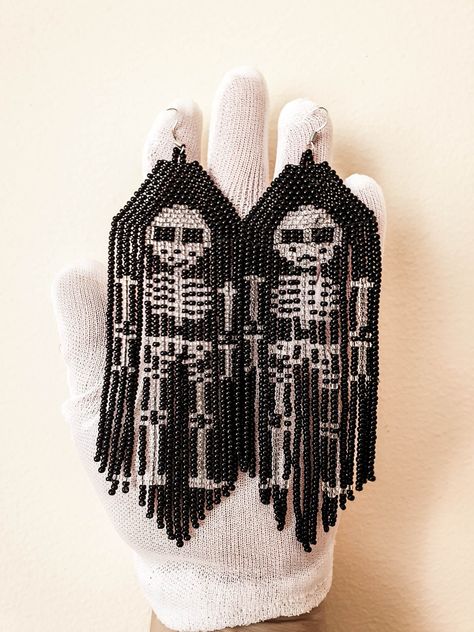 Introducing our enchanting skeleton earrings! These unique and mystical handmade earrings are perfect for the witchy souls out there.  The stunning bead fringe design creates an ethereal feel, while the intricate skeleton jewelry adds an eerie touch.  These goth earrings are the epitome of horror-inspired fashion, making them a must-have accessory for any spooky occasion.  Whether you're looking for quirky earrings  with a touch of goth or a dose of mystery, these goth earrings are sure to make a statement.  Complete your look with these bewitching horror earrings that effortlessly blend bohemian and gothic aesthetics.  Embrace your inner witch and add a dash of mystique to your style with our mesmerizing seed bead earrings! Detail of such skeleton earrings: Size of such horror earrings  e Horror Earrings, Skeleton Jewelry, Gothic Skeleton, Inner Witch, Skeleton Earrings, Goth Earrings, Bead Fringe, Quirky Earrings, Beaded Tassel Earrings