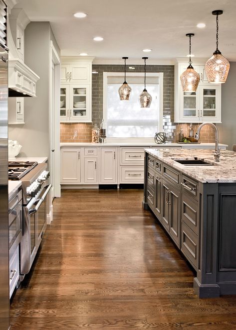 Gray island and white cabinets. Granite top. White oak floor with ebony stain . Gray Subway tile backsplash and mercury glass pendants. Farmhouse Style Kitchen Cabinets, Farmhouse Kitchen Backsplash, Gray Floor, Floor Kitchen, Kitchen Backsplash Designs, Kitchen Cabinet Styles, Honey Oak, Kitchen Cabinets Makeover, Classic Kitchen